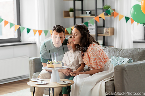 Image of happy family with birthday cake at home