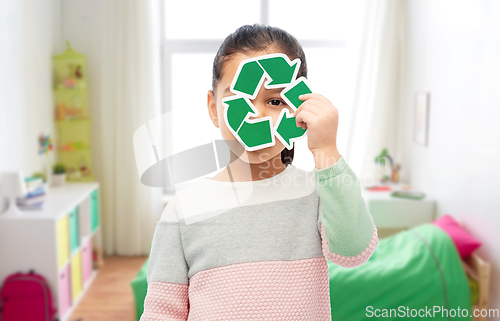 Image of smiling girl holding green recycling sign