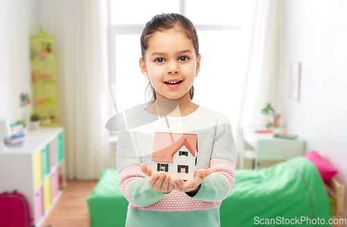 Image of smiling girl holding house model