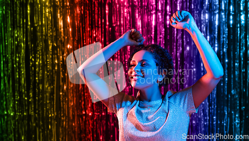 Image of african american woman dancing over neon lights