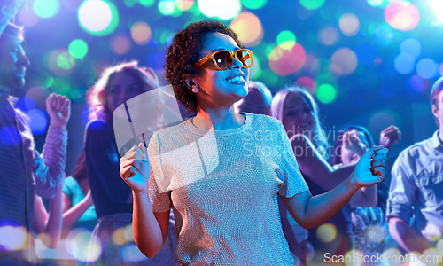 Image of african american woman dancing at nightclub