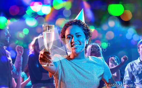 Image of african woman in party cap with glass of champagne