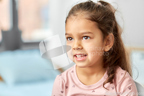 Image of portrait of happy smiling little girl at home