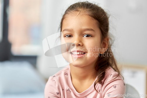 Image of portrait of happy smiling little girl at home