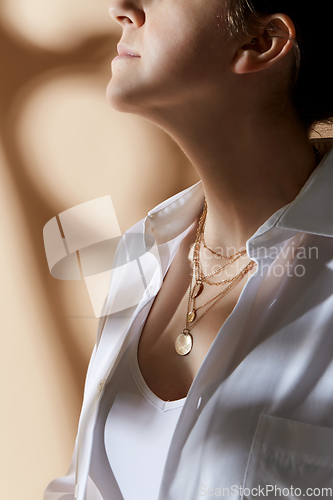 Image of close up of woman with golden jewelry on her neck