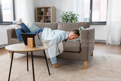 Image of young man sleeping on sofa at home