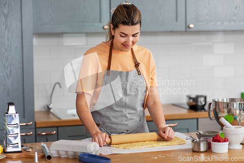 Image of woman cooking food and baking on kitchen at home