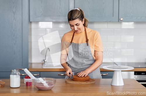 Image of woman cooking food and baking on kitchen at home