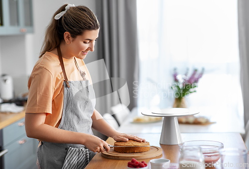 Image of woman cooking food and baking on kitchen at home