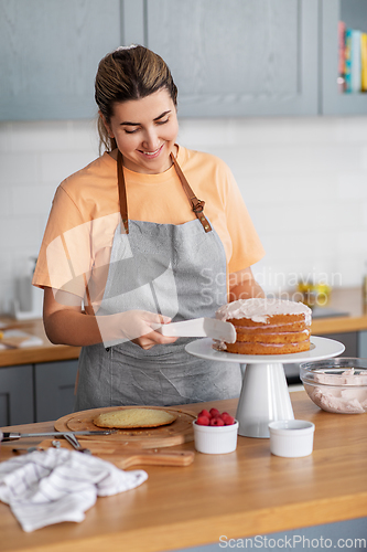 Image of woman cooking food and baking on kitchen at home