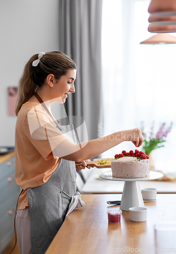 Image of woman cooking food and baking on kitchen at home