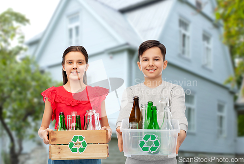 Image of happy children with wooden box sorting glass waste