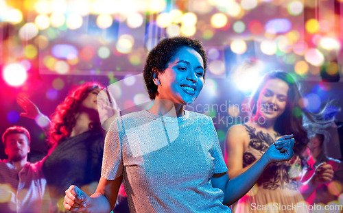 Image of african american woman dancing at nightclub