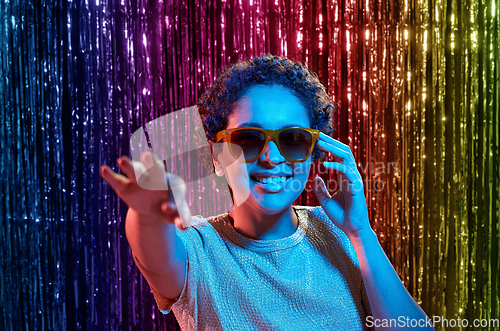 Image of african woman in sunglasses at party