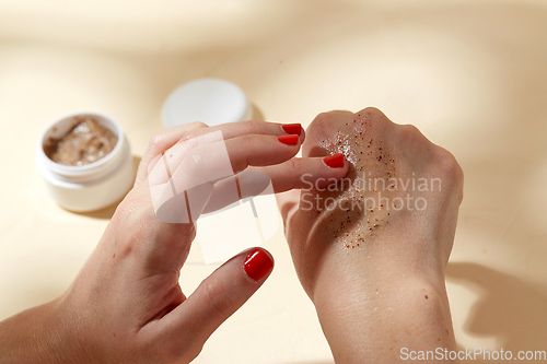 Image of close up of hands applying natural scrub to skin