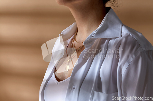 Image of close up of woman with multi layer gold chains