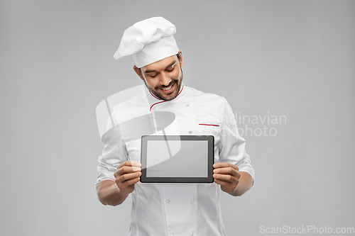 Image of happy smiling male chef showing tablet pc computer