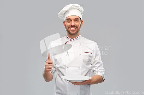 Image of happy male chef with empty plate showing thumbs up