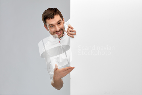 Image of happy smiling male chef with big white board