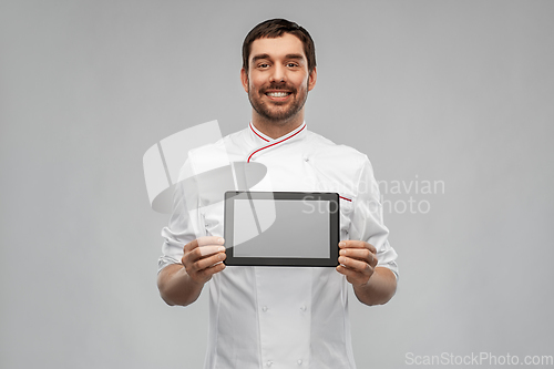 Image of happy smiling male chef showing tablet pc computer