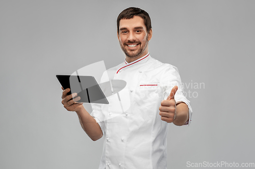 Image of happy male chef with tablet pc showing thumbs up