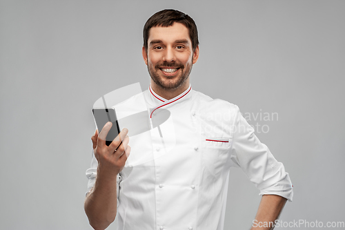 Image of happy smiling male chef with smartphone