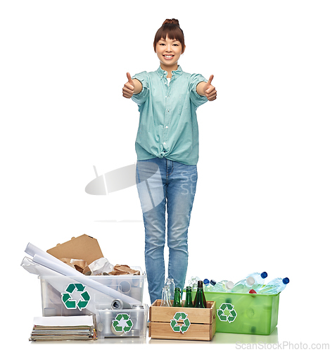 Image of happy woman sorting paper, metal and plastic waste