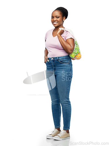Image of african woman with food in reusable string bag