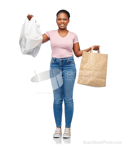 Image of african woman comparing paper and plastic bags