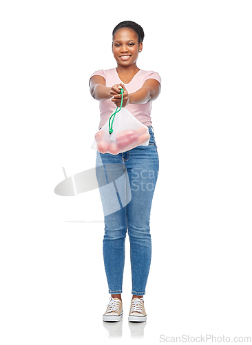 Image of happy woman with vegetables in reusable net bag