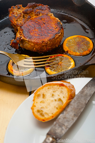 Image of pork chop seared on iron skillet