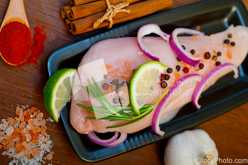 Image of fresh organic chicken breast with herbs and spices