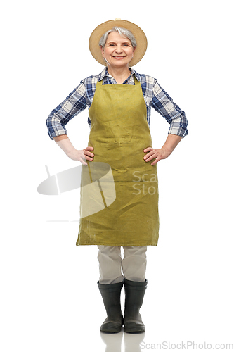Image of smiling senior woman in garden apron and straw hat