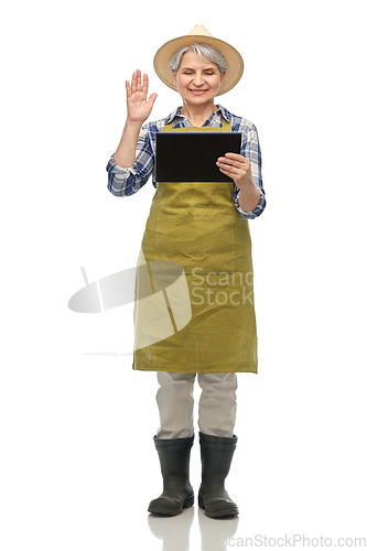 Image of senior gardener with tablet pc having video call