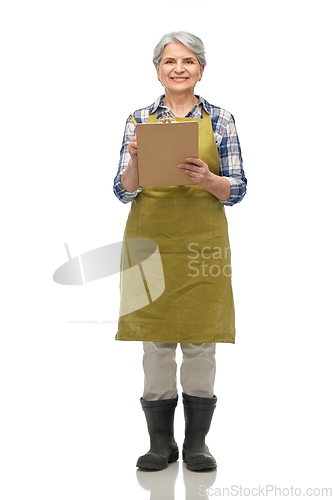 Image of smiling old woman in garden apron with clipboard