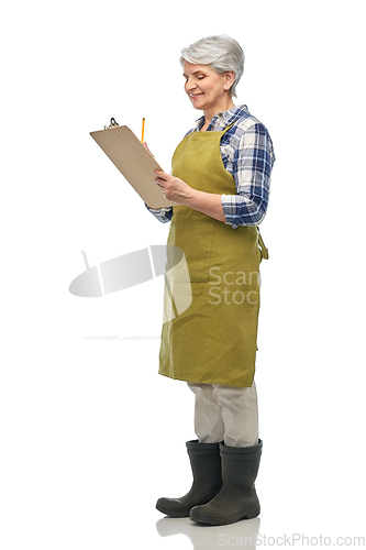 Image of smiling old woman in garden apron with clipboard