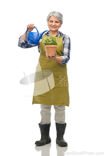 Image of senior gardener with flower and watering can