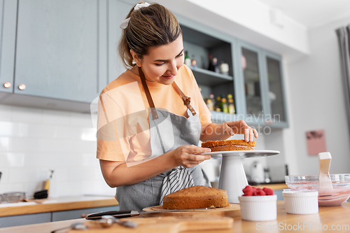 Image of woman cooking food and baking on kitchen at home