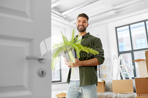 Image of happy man with fern flower and moving to new home