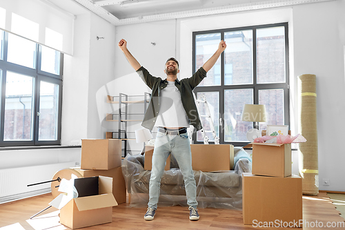 Image of happy man with boxes moving to new home