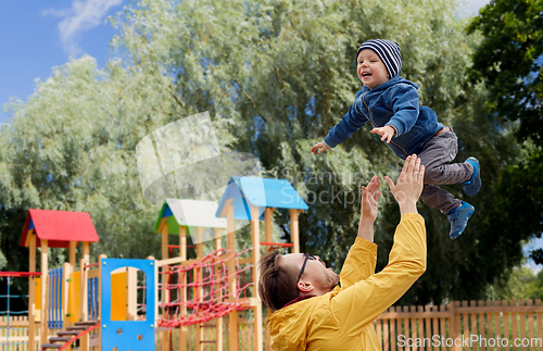 Image of father with son playing and having fun outdoors