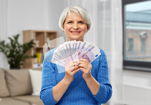 Image of senior woman with hundreds of euro money banknotes