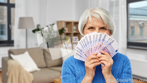 Image of senior woman with hundreds of euro money banknotes