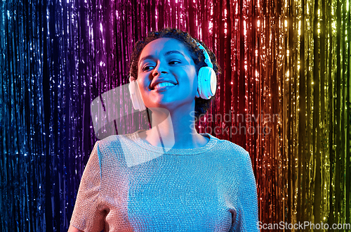 Image of woman in headphones listening to music at party