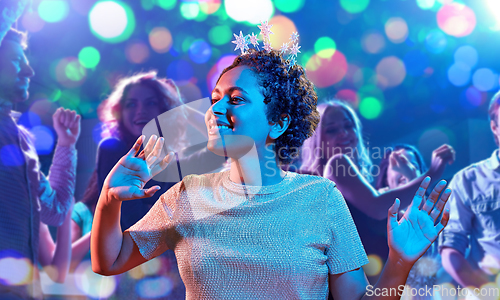 Image of african woman dancing at party at nightclub