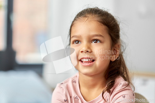 Image of portrait of happy smiling little girl at home