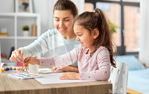 Image of mother with little daughter drawing at home