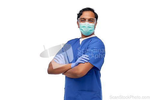 Image of indian male doctor in blue uniform and mask