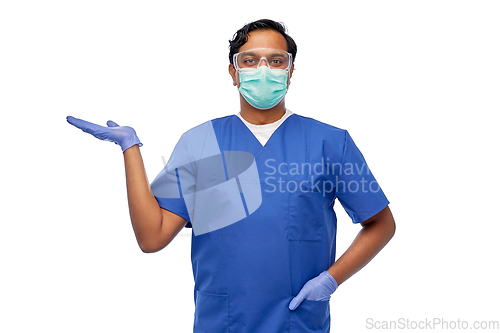 Image of indian male doctor in mask holding something