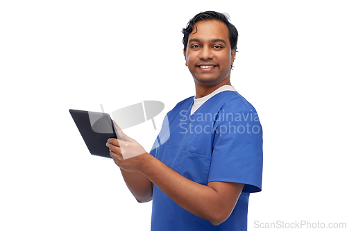 Image of smiling doctor or male nurse using tablet computer